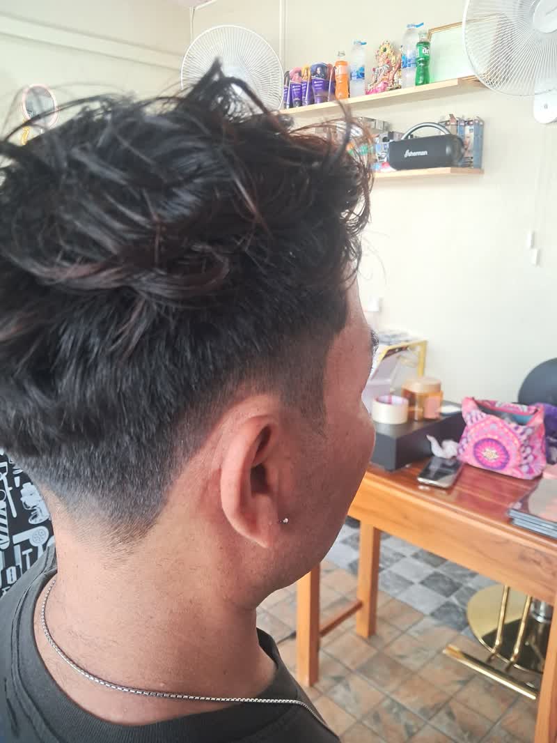 Fresh fade with long wavy hair left on top