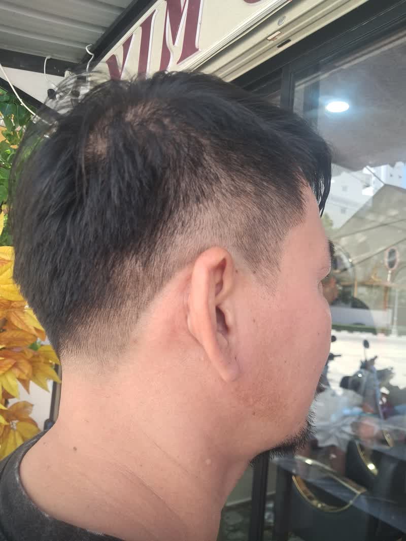 Side and back of a fresh undercut fade on dark hair