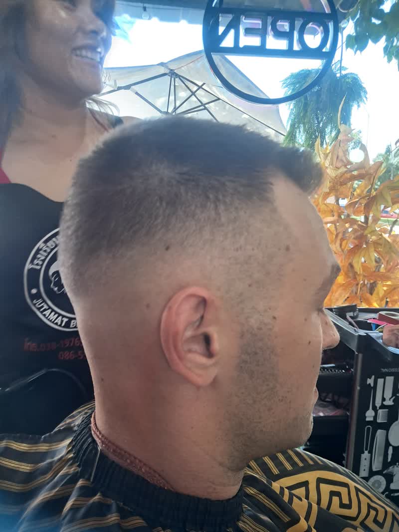 Fresh high fade, client still in the barber cape