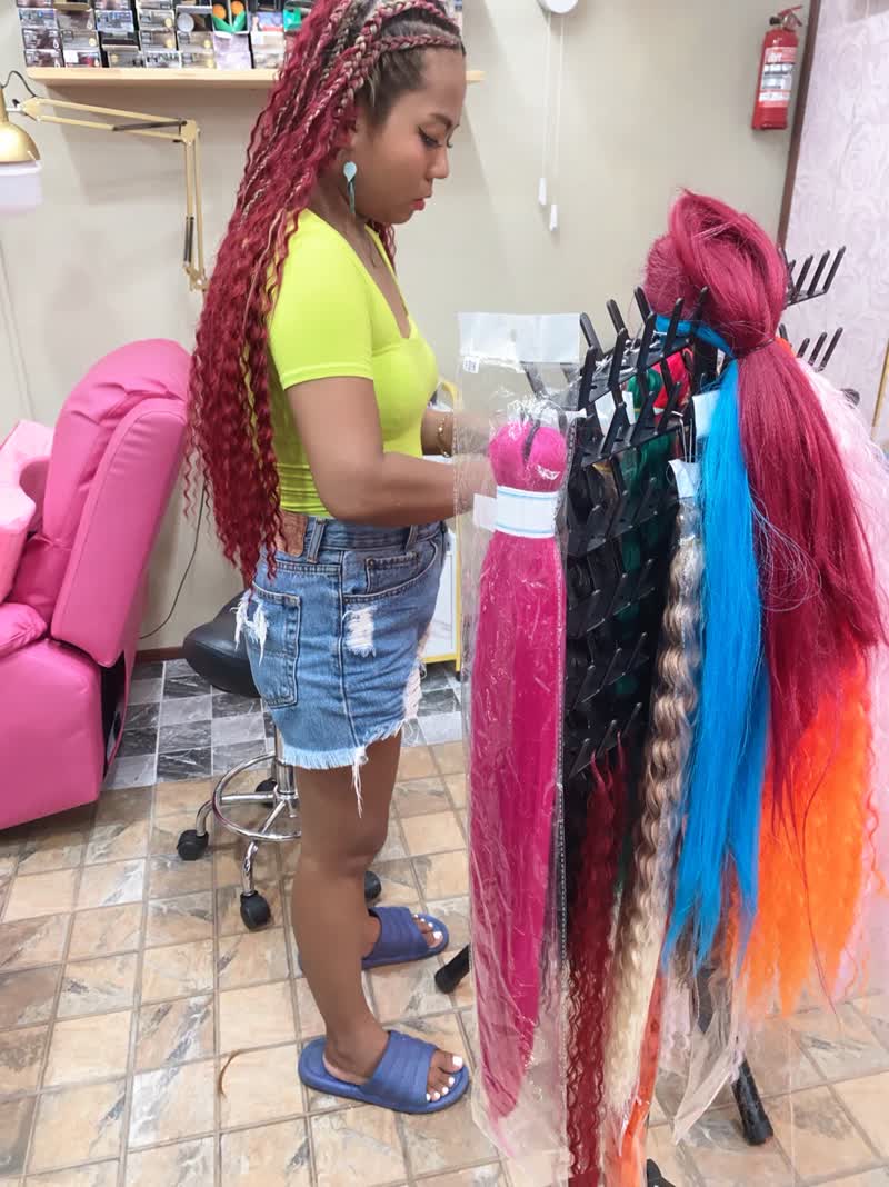 Choosing colours from the rack of braiding hair