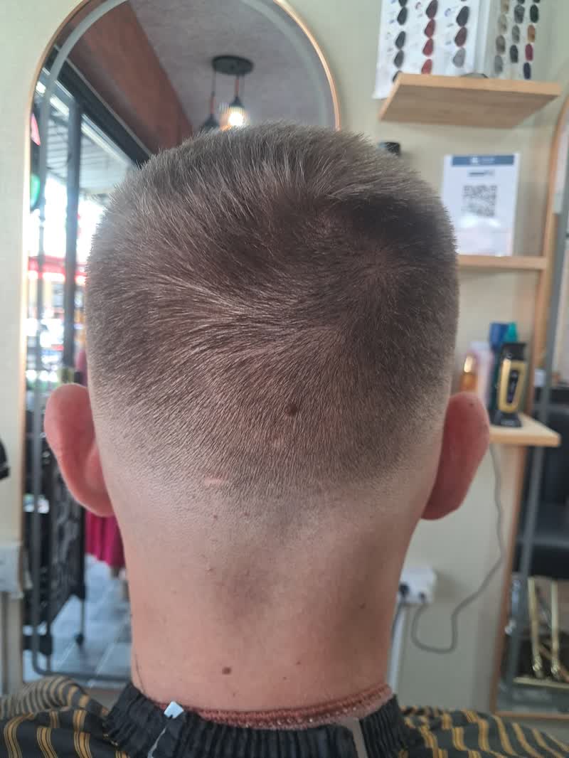 Back of a short fade haircut in the salon mirror