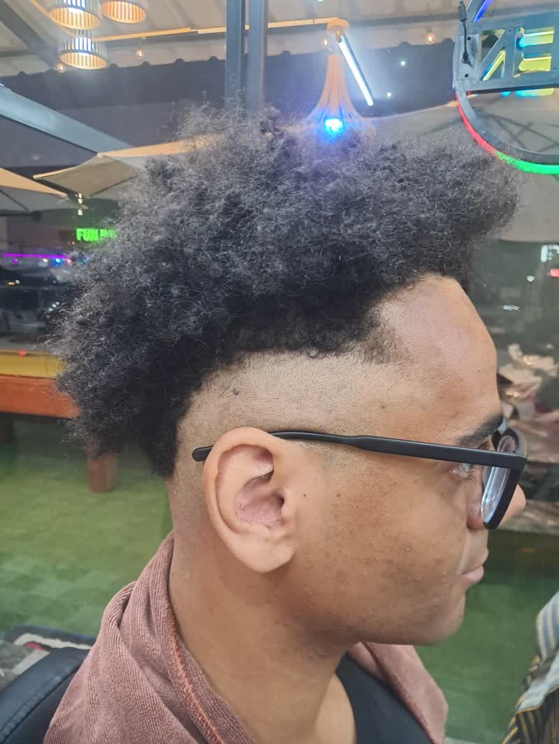 Curly afro with a tight high fade